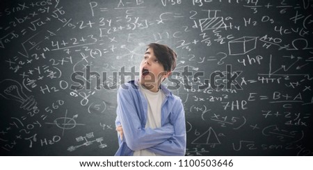 student with surprise and frightened looking at the formulas on the blackboard