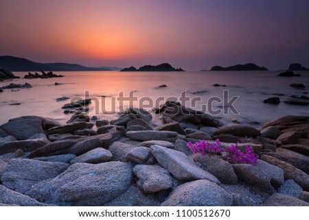 Sunrise landscape photo at beautiful bay with rocks on a front