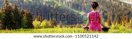 Young people sitting on a mountaintop. Banner for website. The concept of a healthy lifestyle, travel and yoga.