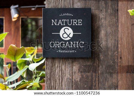 Black signage on a rustic wooden wall mockup