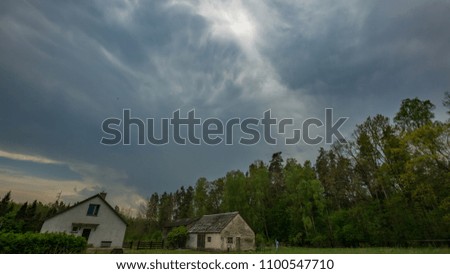 Storm clouds over rural landscape. Beautiful dramatic sky in polish landscape.