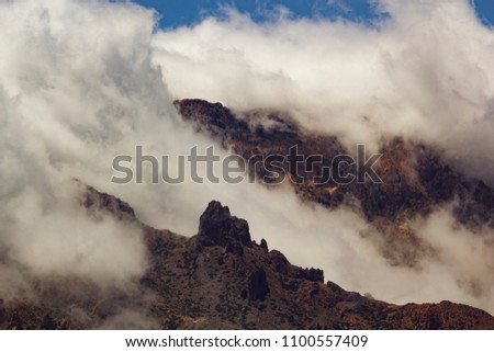 Teide Nacional Park. Mountains of Tenerife. Clouds floating over mountains.