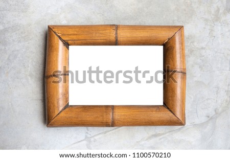 White background on bamboo wood picture frame on grey cement wall