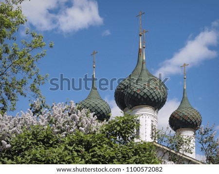 Spring blooming lilac against the background of the domes and crosses of the Orthodox Church, the picture was taken in Yaroslavl