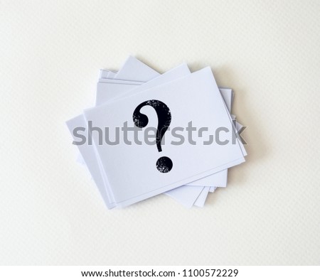 stacking of  white business card with written question mark symbol  on white paper background , Questions and Answers or Q&A concept design