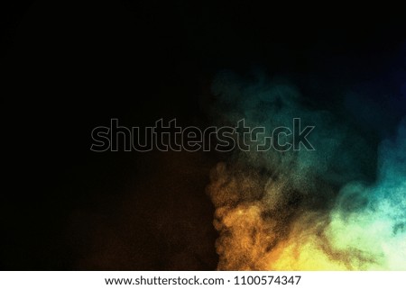 Multicolor powder explosion on black background. Colored cloud. Colorful dust explode.