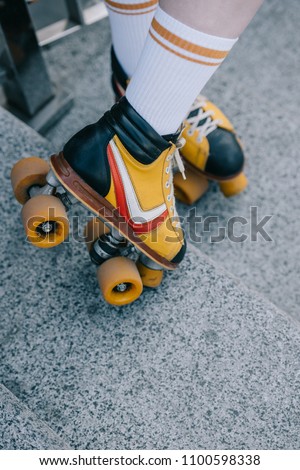 close-up partial girl on girl wearing roller skates on stairs