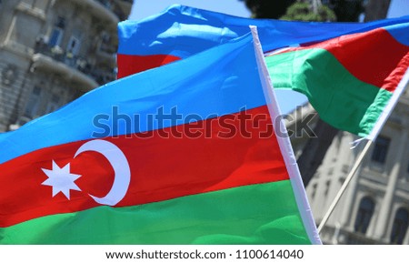 The Azerbaijani flag is on the background of the city. Red Green Blue flag. Azerbaijan tradition patriotic. Flags waving wind