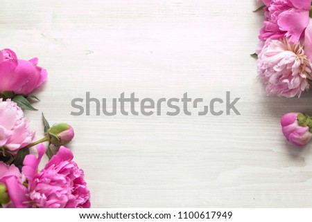 Floral pattern, beautiful pink peonies on wooden white background. Flat lay, top view. Wedding background.