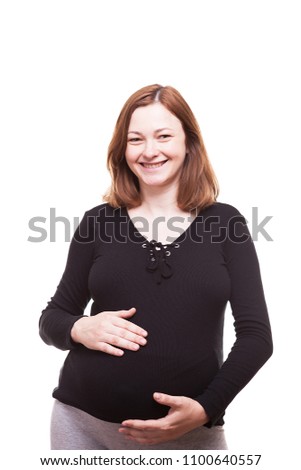 Smiling pregnant woman isolated over white background in studio photo