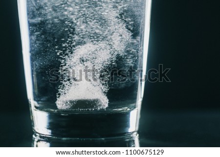 Tablet dissolving in water. Concept - headache, cold, medicine, medicine