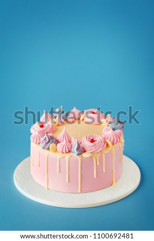 Birthday cake isolated on a blue background. Birthday party decorated cake with candles and sparkles. Copy space