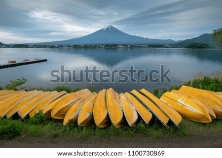 Fuji mountain and fishing boats at Kawaguchiko lake, Japan.