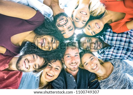 Multiracial best friends millennials taking selfie outdoors with back lighting - Happy youth friendship concept against racism with international young people having fun together - Azure filter tone Royalty-Free Stock Photo #1100749307