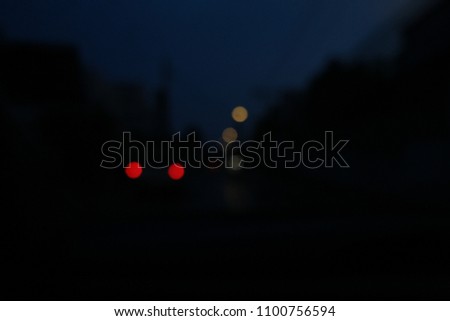 Defocused image, street lights at night, colorful bokeh, abstract background.