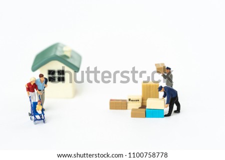 Miniature people, workers moving stuffs to new house. Concept of moving house, relocation.