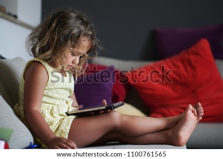 baby girl playing with mobile phone