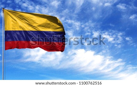 Flag of Colombia on flagpole against the blue sky