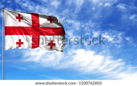 Flag of Georgia on flagpole against the blue sky