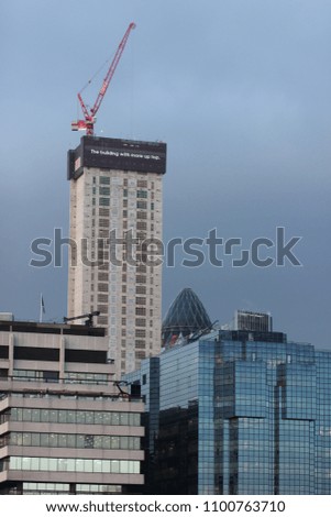 a crane on top of modern buildings, London, England