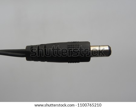 Black color male jack of power plug adapter on white background