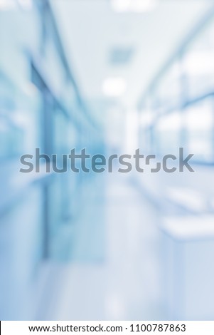Abstract blur blue tone image of bright and clean Window , Door and corridor in modern office building on day time for background usage.(vertical)