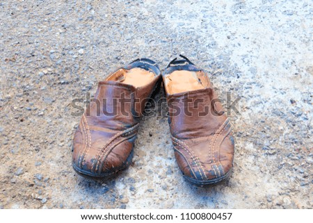 old shoes leather worn out On floor road background