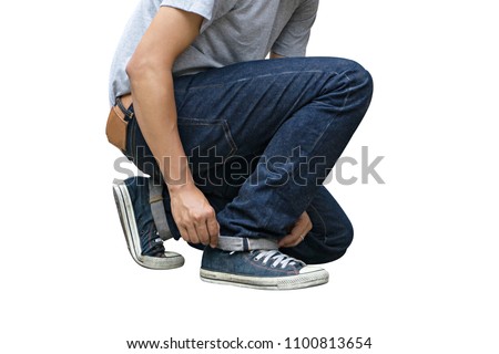 Regular Fit Straight Leg Jeans and Retro Canvas High Top Sneakers isolated on white background, selective focus (detailed close-up shot) Royalty-Free Stock Photo #1100813654