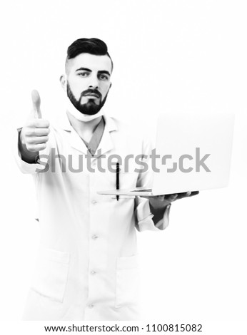 Doctor with beard holds white laptop and shows thumbs up