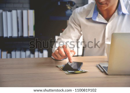 Asian smart man working with tablet,smartphone and notebook in the office. Workplace,business,investment,financial concept.