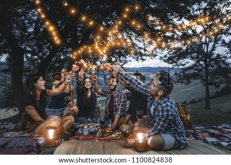 Group of friends making barbecue in the nature - Happy people having fun on a pic-nic in the countryside Royalty-Free Stock Photo #1100824838