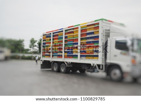 Chicken cages behind the truck for mass  transportation from farm to slaughterhouse