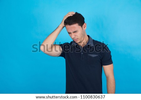 Handsome man wearing a casual outfit and looking so regret hitting his forehead with his hand, standing on a blue background