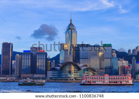 Cityscape in Hong Kong with illuminated buildings. Victoria harbour at sunset in Hong Kong