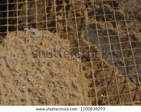abstract composition of metal mesh and plaster, blurred