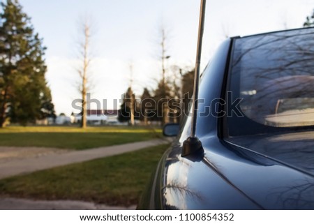 Close-Up of a car antenna from behind in park |sunset