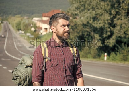 Face fashion boy or Man in your web site. Man face portrait in your advertisnent. Bearded hipster man travel with backpack on road on sunny summer day on natural landscape. Hiking, hitchhiking, auto