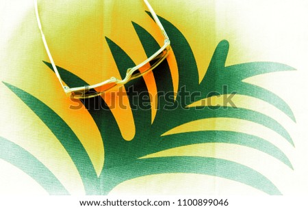 Stylized tropical composition with sunglasses and palm tree leaf pattern. Summer vacation concept.