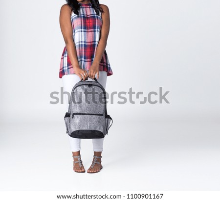 Young Stylish Girl Standing with a Gray Backpack