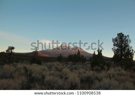 A photo of Mount Shasta from the valley below eat sunset.