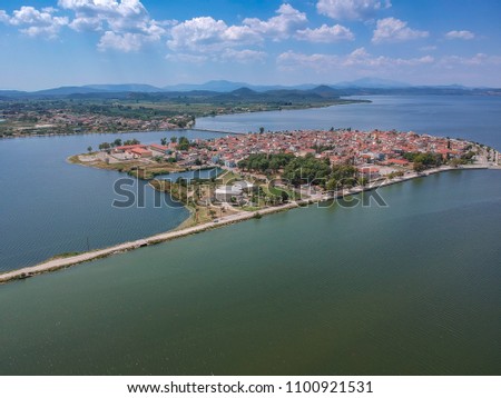 Aerial scenic view of the famous island - town of Aitoliko in Aetolia - Akarnania, Greece is situated in the middle of Messolonghi Lagoon and it is known as the Little Venice of Greece. Royalty-Free Stock Photo #1100921531
