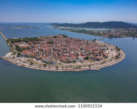 Aerial scenic view of the famous island - town of Aitoliko in Aetolia - Akarnania, Greece is situated in the middle of Messolonghi Lagoon and it is known as the Little Venice of Greece. Royalty-Free Stock Photo #1100921534