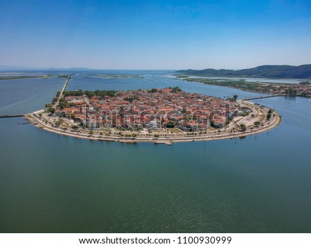 Aerial scenic view of the famous island - town of Aitoliko in Aetolia - Akarnania, Greece is situated in the middle of Messolonghi Lagoon and it is known as the Little Venice of Greece. Royalty-Free Stock Photo #1100930999