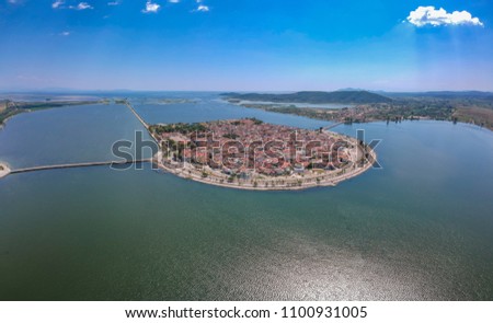 Aerial scenic view of the famous island - town of Aitoliko in Aetolia - Akarnania, Greece is situated in the middle of Messolonghi Lagoon and it is known as the Little Venice of Greece. Royalty-Free Stock Photo #1100931005