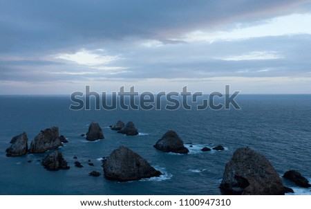 Rocks in sea during sunset in Nugget Point in New Zealand