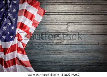 American flag on a old wooden. star striped flag of the USA on rough dark wooden surface with blank space for text