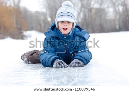 boy little have fun winter outdoor on skating-rink