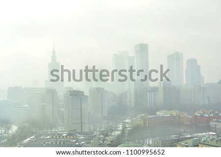 Characteristic view of a modern city skyline covered in a dense smog and pollution Royalty-Free Stock Photo #1100995652