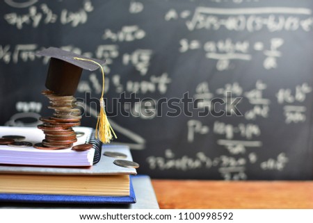 hat graduation model on coins saving for concept investment education and scholarships  Royalty-Free Stock Photo #1100998592