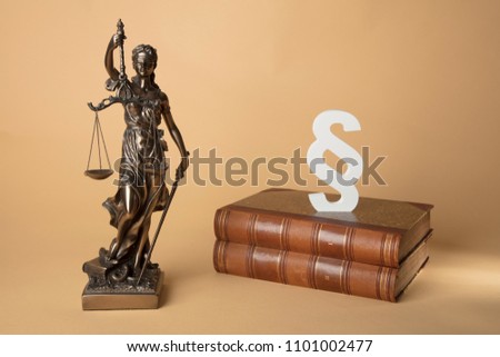 Justizia Figure old Books and section mark on beige Background
